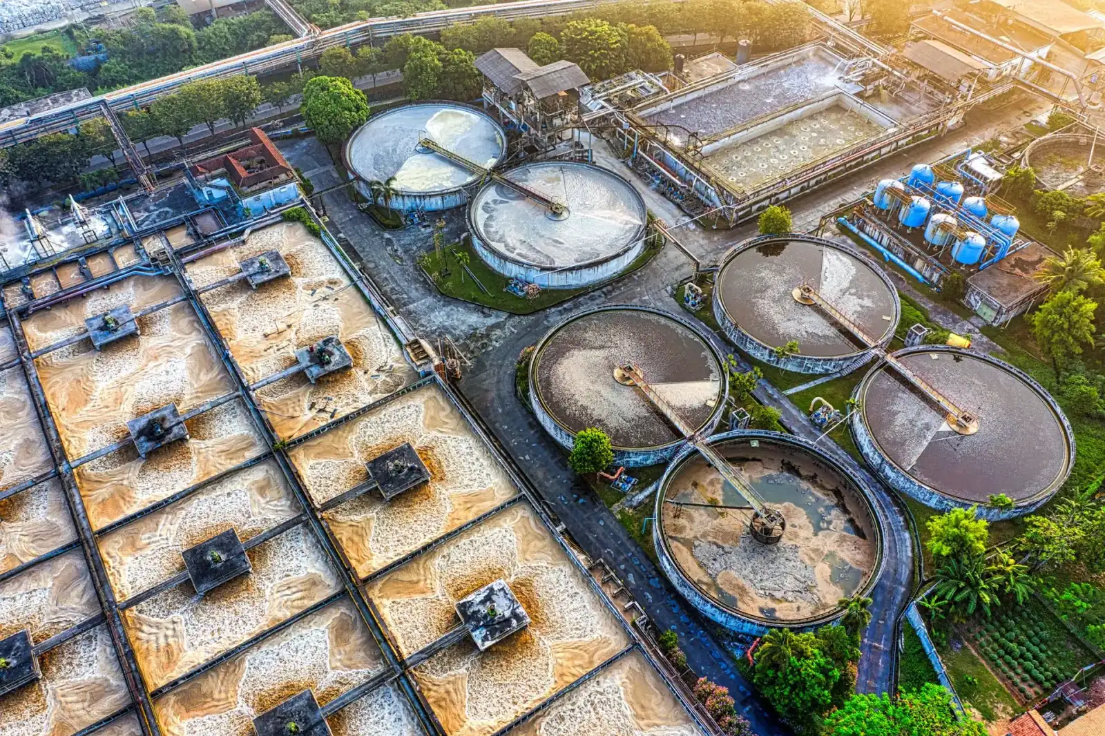Aerial view of a wastewater treatment works with circular clarifier tanks